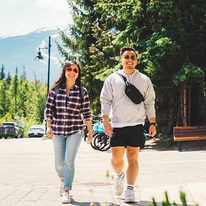 Couple enjoying a sunny walk after parking their Evolve e-scooter
