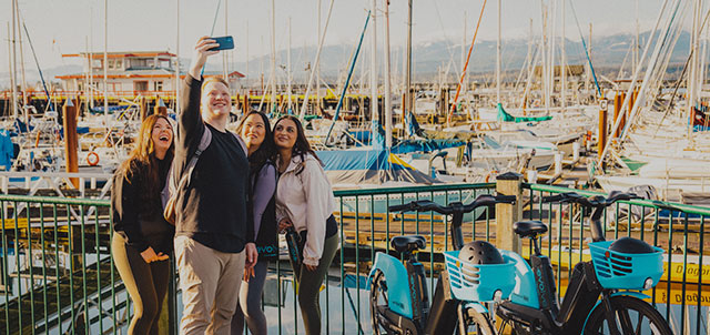 A group of friends in taking selfie at sea deck